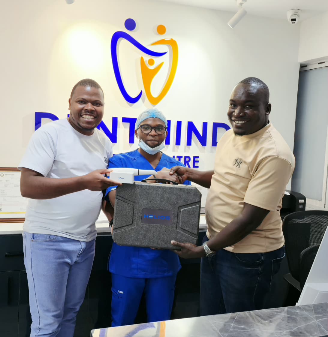 Dentist team at DentMind CBD holding the new intraoral scanner in Nairobi.