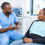 Dentist explaining common dental myths Kenyans believe to a patient at a Nairobi dental clinic.