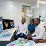 Bone grafting for dental implants Nairobi patient consulting a dentist with a jaw scan.