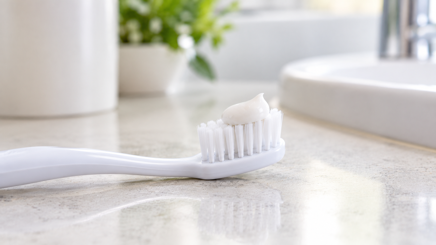 Pea-sized amount of fluoride toothpaste on a toothbrush.
